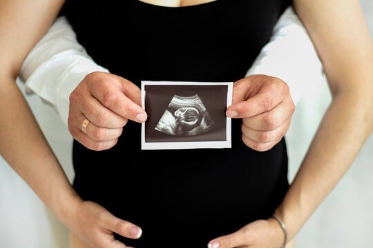 Pregnancy, pregnant woman with husband, holding small shoot, waiting for child, pregnant, waiting for a miracle, picture of a pregnant girl, snapshot of pregnancy, the expectation of a child. 