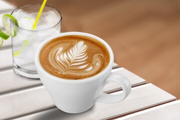 Hot aroma cup of coffee on desk board