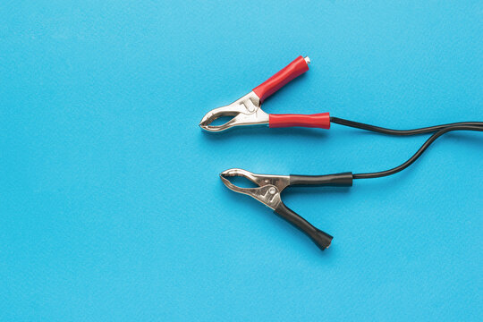 Red and black terminals for connecting to the battery on a blue background.