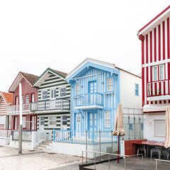 Vintage beautiful colored striped houses in a fishing resort town by the sea in Portugal