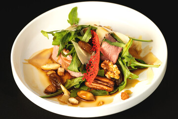 green salad with arugula, pastrami, parmesan, walnuts,almonds, raisins and gravy