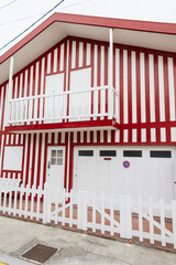 Vintage colored striped cottages at a resort near the ocean in Portugal. Apartments. Creative homes. Red striped colors.