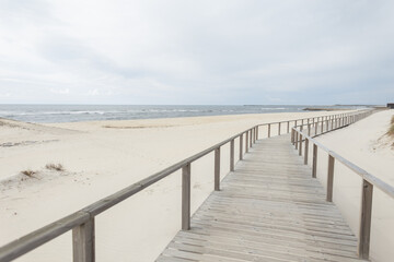 Fototapeta na wymiar Beautiful Wooden Walkway on the Beach along the Ocean