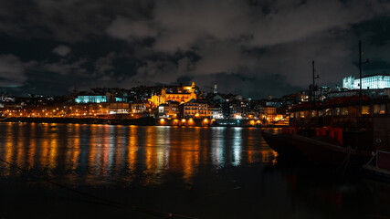 Beautiful European old night town of Porto near the river. Vintage city of Porto, Portugal with lights