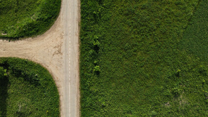 Aerial view of green summer forest road. road from above.