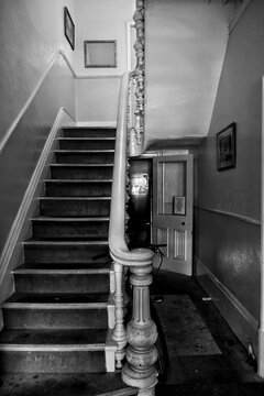 A black and white urban image of a tatty hallway in an old Victorian house, now flats. Kingston upon Hull, UK 