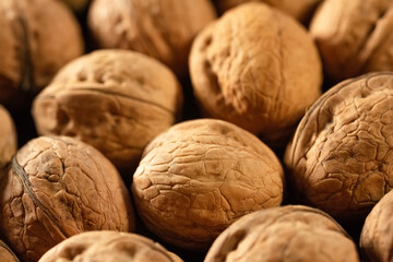 Walnuts with shells close-up. Background of fresh walnuts, food background