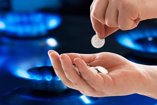 Gas burner and ruble coin, Russian money on home gas stove. Concept of Russia and Europe economy, natural gas cost, inflation, sanctions and payment.