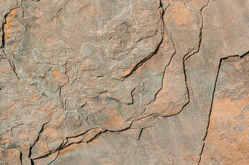 Stone background for manufacture of floor tiles. Textured stone art background in brown colors close-up.