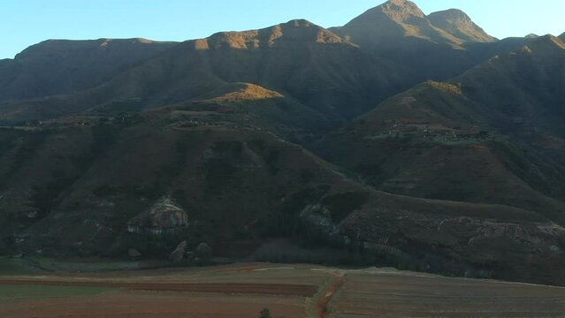 Lesotho mountains by sunrise Lesotho farmhouse 
rural Lesotho