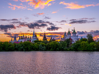 Fototapeta na wymiar Beautiful landscape with Izmaylovo Kremlin behind river and lush greenery, Moscow, Russia