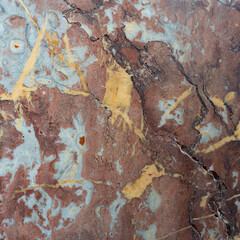 Red marble with large white flecks and vertical veins