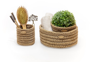 hand knitted jute boxes for the interior on a white background, bathroom accessories in baskets