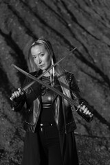 Warrior woman in leather jacket with two vintage swords in black and white