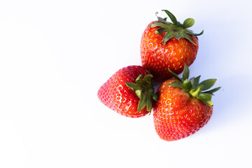 Three strawberries on white