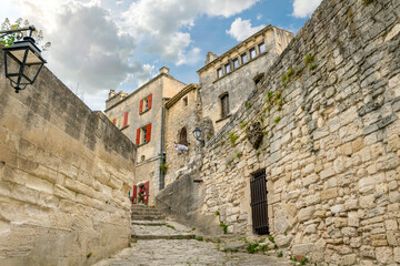 Fototapeta na wymiar A narrow alley leading to the walled village of Les Baux-de-Provence, France, in the Alpilles Mountains of the Cote d'Azur region of southern France.