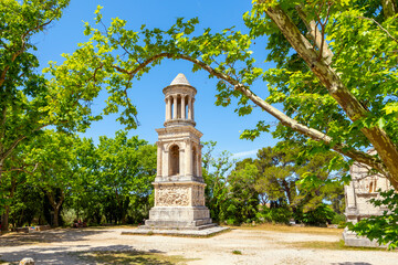 The ancient Roman Mausoleum of the Julii alongside the triumphal arch at the historic Glanum archaeological site near Saint-Remy-de-Provence in the Provence region of Southern France.