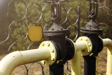 Yellow gas pipes and valves outdoors. gas equipment. Copy space for text. High quality photo