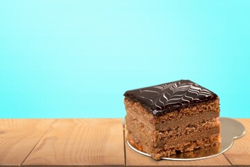 Tasty homemade chocolate cake on the plate on the desk
