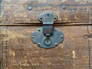 The old lock on the suitcase.Details of a vintage clothing chest. Retro furniture details.