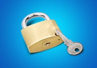 Simple lock and key. Small worn padlock with shiny key. Business data encryption, home security, or other safeguarding metaphor.