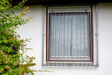 view of steal window grid at a home from outside