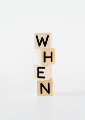 Cubic wooden blocks forming the 'when' text