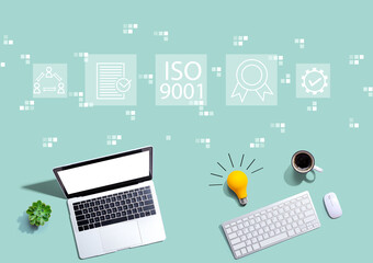 ISO 9001 concept with computers with a light bulb from above