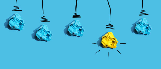 Brainstorming concept with crumpled paper light bulbs - Flat lay