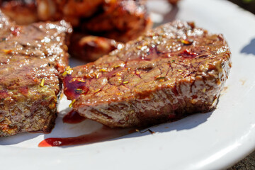 Juicy Grilled Beef Steak on a White Plate with Beautiful Bokeh