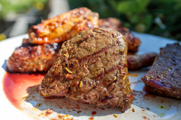 Juicy Grilled Beef Steak on a White Plate with Beautiful Bokeh
