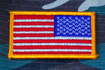 Fabric bent flag of Ukraine, UA. Blue and yellow colors. USA patch on army uniform. Stop the war....