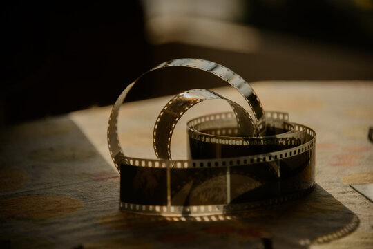 close up of a film negative analogue photo in the afternoon golden hour on a table