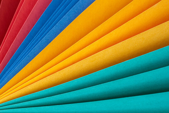 Multi-colored sheets of paper folded like rainbow fan. Abstract colorful background