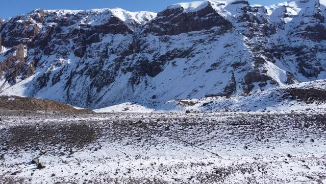 drone tour of the imposing snowy mountain in the andes mountain range on a cold sunny day in winter season