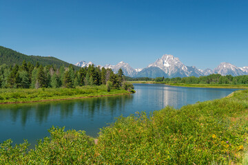 Fototapeta na wymiar Snake river by Oxbow Bend in summer with Grand Tetons peaks in background, Grand Teton national park, Wyoming, USA.