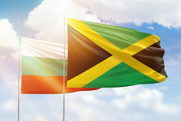 Sunny blue sky and flags of jamaica and bulgaria