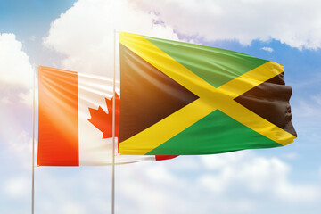 Sunny blue sky and flags of jamaica and canada