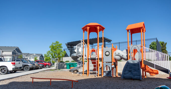 Wide Shot Of Children's Playground With Parking Lot