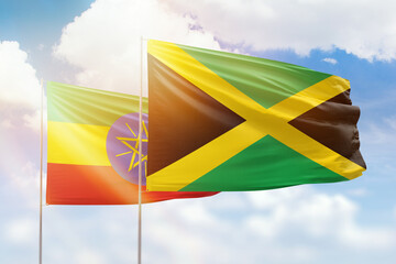 Sunny blue sky and flags of jamaica and ethiopia