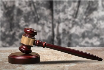 Military Law concept, soldier and wooden gavel at courtroom.