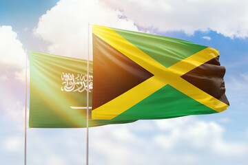 Sunny blue sky and flags of jamaica and saudi arabia