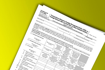Fototapeta premium Form 8858 (Schedule M) documentation published IRS USA 09.30.2021. American tax document on colored