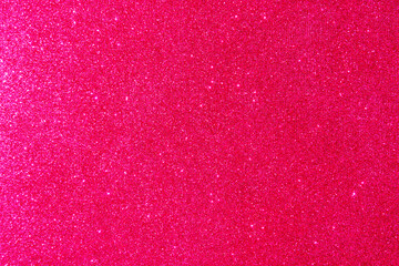 Background with sparkles. Backdrop with glitter. Shiny textured surface. Vivid pink