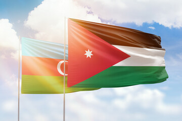 Sunny blue sky and flags of jordan and azerbaijan
