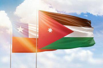 Sunny blue sky and flags of jordan and chile