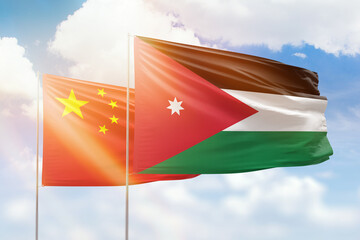 Sunny blue sky and flags of jordan and china