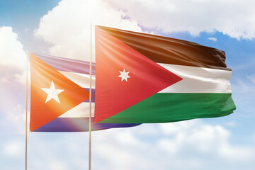 Sunny blue sky and flags of jordan and cuba