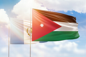 Sunny blue sky and flags of jordan and guatemala