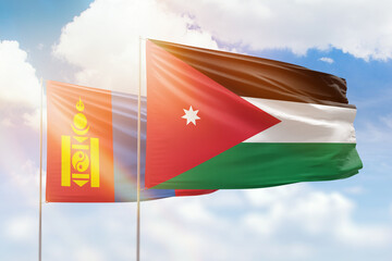 Sunny blue sky and flags of jordan and mongolia